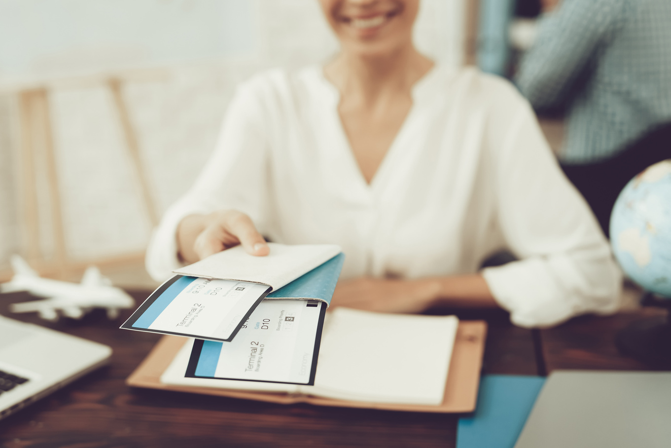 Travel Agent Holding Tickets in Travel Agency.